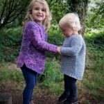 two children wearing the garter squish kids jumper - side view