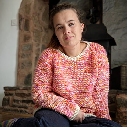 garter squish adult jumper from the front shown on a women. all over garter stitch and shaped neckline visible with slipped knit stitches along the raglan shaping