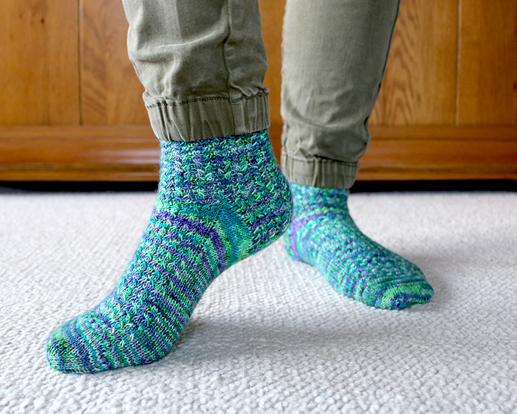 Over the ocean socks shown under a pair of green trousers